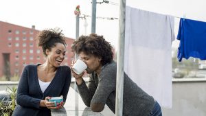 young mixed raced couple is drinking tea on roof top